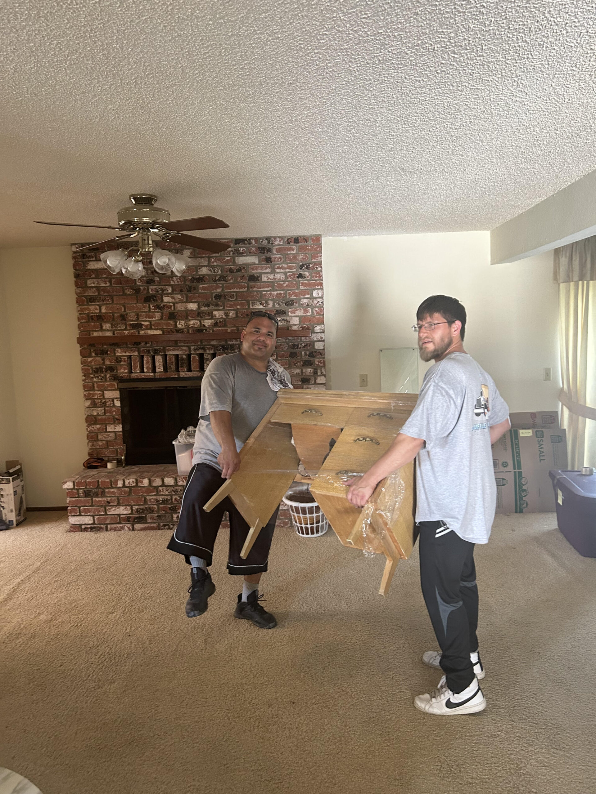 Wildomar Movers | Duffle Bag Movers team in action professionally moving furniture in a home.